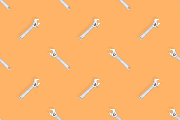 Adjustable metal wrench seamless pattern. Adjustable metal wrench on a colored background.