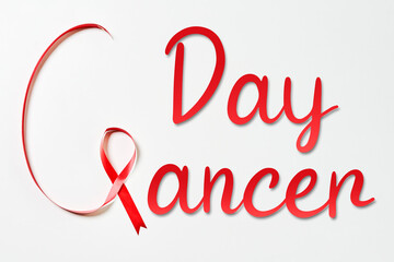 Cancer day written with red ribbon. World cancer day.