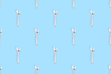 Adjustable metal wrench seamless pattern. Adjustable metal wrench on a colored background.