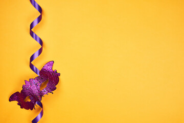 Celebration Mardi Gras, or Fat Tuesday. Carnival masks on yellow background with copy space