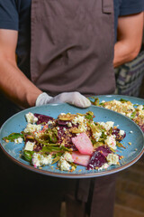Salad with cottage cheese and fresh vegetables on plate served in a restaurant or diner.