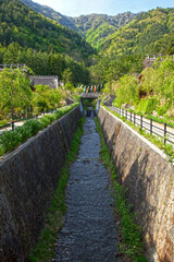 Fototapeta na wymiar A stream and hills where the traditional village of Saiko Iyashi no Sato Nemba is located near Mount Fuji in Japan.