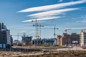 Fototapeta na wymiar New neighborhood with buildings under construction with cranes.