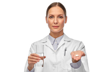 medicine, profession and healthcare concept - female doctor with pill and glass of water over white background