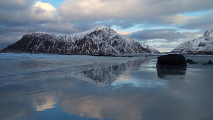 view from the beach to the snow-covered mountain