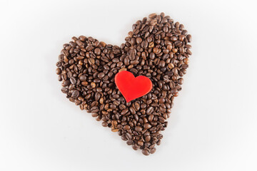 Coffee beans in heart shape with a Small red heart. White background isolated