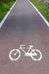 Obraz premium Cycle path with road signs in the woods.
