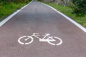Obraz premium Cycle path with road signs in the woods.