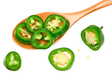 sliced jalapeno peppers with wooden spoon isolated on white background. Green chili pepper. Capsicum annuum. top view