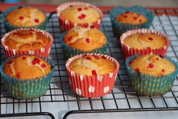 Muffins or cupcakes with cooling rack background, baking concept 