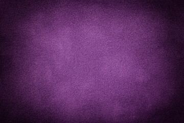 Purple matte background of suede fabric with vignette. Texture of velvet textile