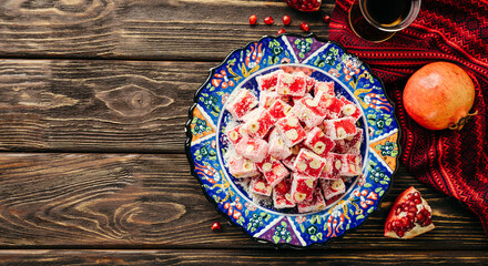 Lokum. Turkish delight in a plate with ethnic ornament.