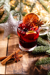Christmas mulled wine with spices on a wooden rustic table.