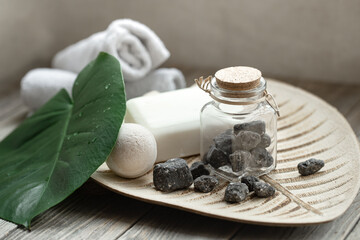 Spa composition with bath accessories and leaf close up.