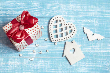 A festive composition for Valentine's Day with a gift box and wooden decor details close up.