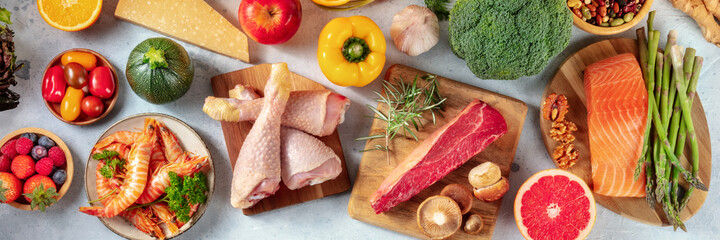 Food variety panorama, shot from above. A selection of healthy foods, meat and fish, fruit and...