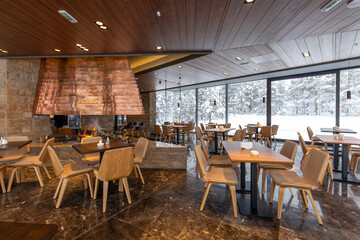 Interior of an empty mountain restaurant with fireplace