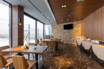 Interior of an empty mountain restaurant with marble floor