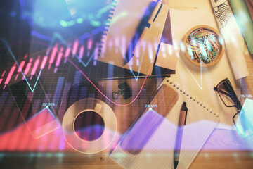 Fototapeta na wymiar Double exposure of forex graph drawing and work table top veiw. Concept of financial analysis.