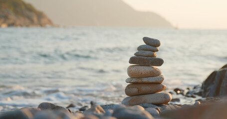 Balanced Pebble stone at beach in sunset time