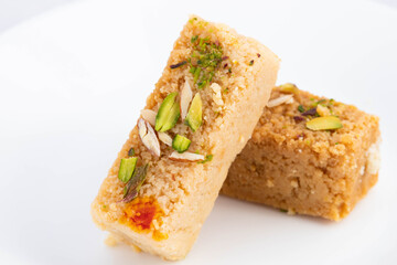 Delicious Indian Mithai Hot Milkcake Kalakand Burfi Or Alwar Ka Mawa Barfi Made Of Khoya Doodh Malai Decorated With Badam Or Badaam Nuts Kaju And Pista. Isolated On White Background With Copy Space