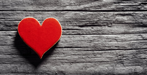 Red heart on a wood background concept for love, dating and romance with copy space