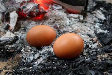 Grilled eggs over hot coals during winter in Thailand.