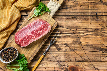 Raw Top Blade beef meat steak. wooden background. Top view. Copy space