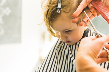 the little boy in a hairdressing salon
