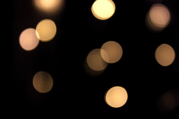 Yellow circles on black background bokeh effect. 