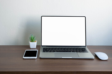 Wooden office desk table with keyboard of laptop with empty screen and phone, mouse computer. Business and finance concept. Workplace, Flat lay with blank copy space.