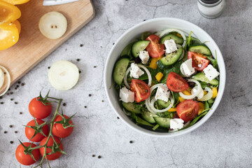 Green vegan salad made from a mixture of green leaves and vegetables.