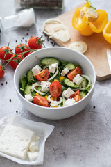 Green vegan salad made from a mixture of green leaves and vegetables.