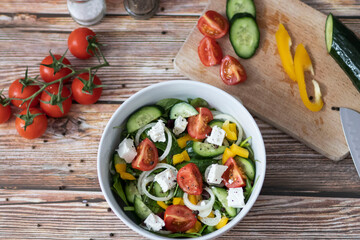 Green vegan salad made from a mixture of green leaves and vegetables.