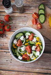 Green vegan salad made from a mixture of green leaves and vegetables.