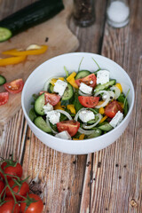 Green vegan salad made from a mixture of green leaves and vegetables.