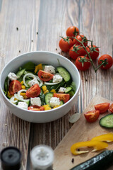 Green vegan salad made from a mixture of green leaves and vegetables.
