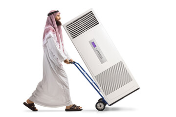 Saudi arab man pushing a hand truck with a self standing AC unit