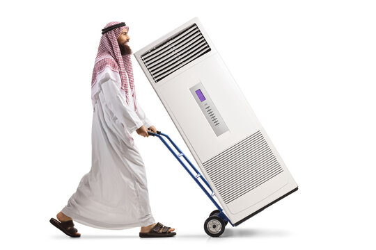 Saudi Arab Man Pushing A Hand Truck With A Self Standing AC Unit