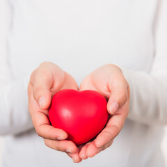 Love Valentine's Day. Female beauty hands holding modern a red heart isolated on white background, giving help donation medical healthcare happy holiday background concept