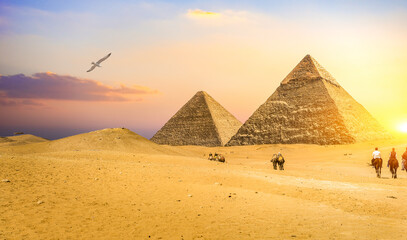 Fototapeta na wymiar Riders near pyramids