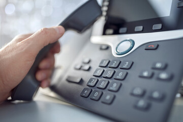 Dialing a telephone in the office concept for communication, contact us and customer service support