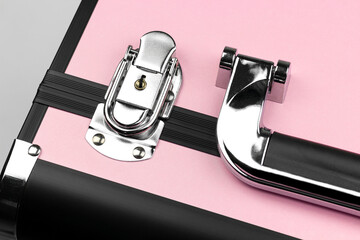 pink suitcase close-up handle and locks, professional makeup artist's cosmetic bag