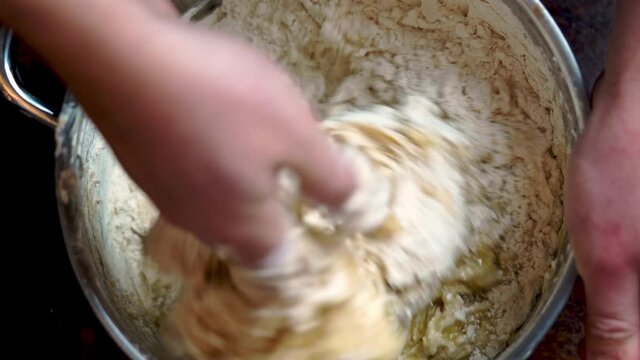 Italian Pizza Dough. chef mixes the ingredients for the dough with his hand DIY homemade dought concept.