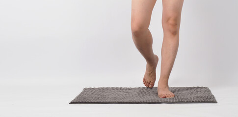 Legs of male barefoot walking on soft carpet. with white background.isolated and copy space