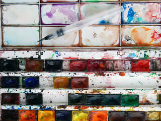 watercolor paints with palette and brush for drawing