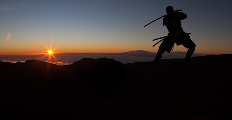 Fototapeta na wymiar Silhouette of a Japanesesamurai with sword training during sunset