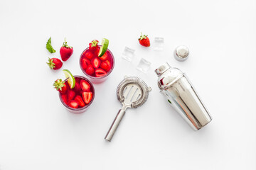Red drink coktail with strawberry, ice and mint. Cocktail making bar tools