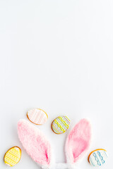 Happy Easter. Bunny ears with colorful eggs cookie, top view