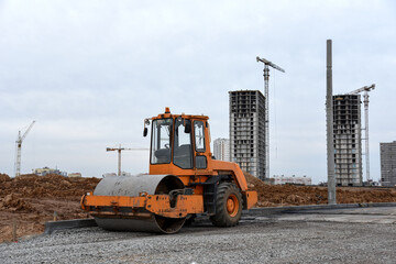 Vibro Roller Soil Compactor leveling soil at construction site. Excavator and vibration...